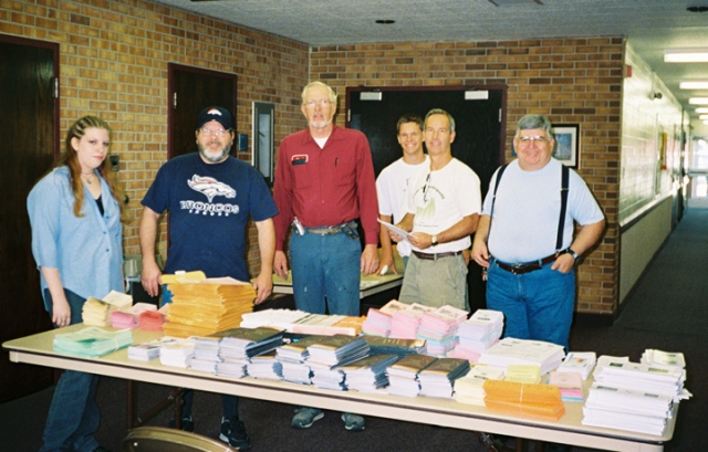 Left to right: Erica Smith, David Smith, Jared Petersen, Jason Aldridge, Bruce Aldridge, and Patrick Lovato lay out materials to be put together in packets and distributed to residents for the City and County of Broomfield as a Colorado Cares Day 2004 community service on Aug. 31, 2004.